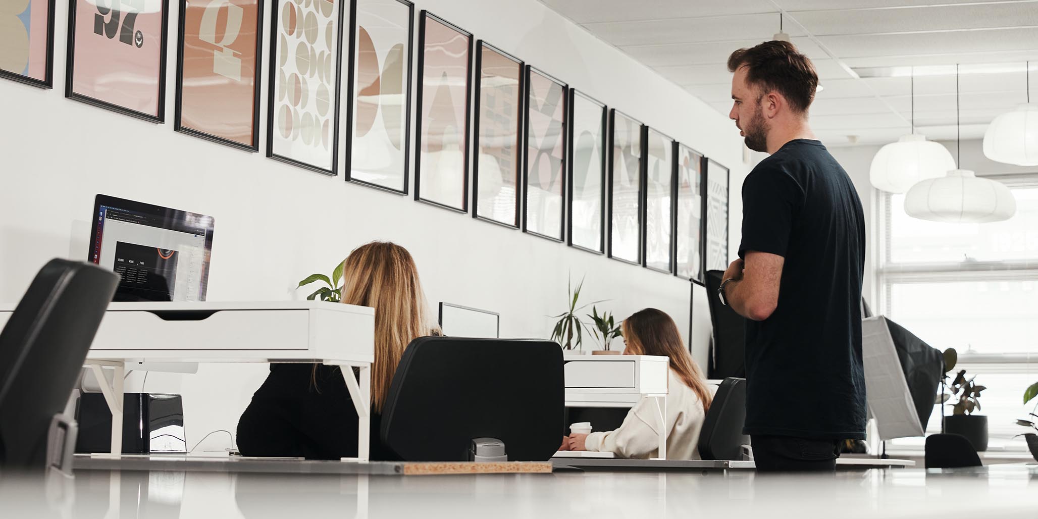 This photo shows workers inside Brand agencies Sydney, such as Percept. It depicts branding strategy & brand identity design being carried out by the creative Brand Designers at Percept, the Brand Agency Sydney.